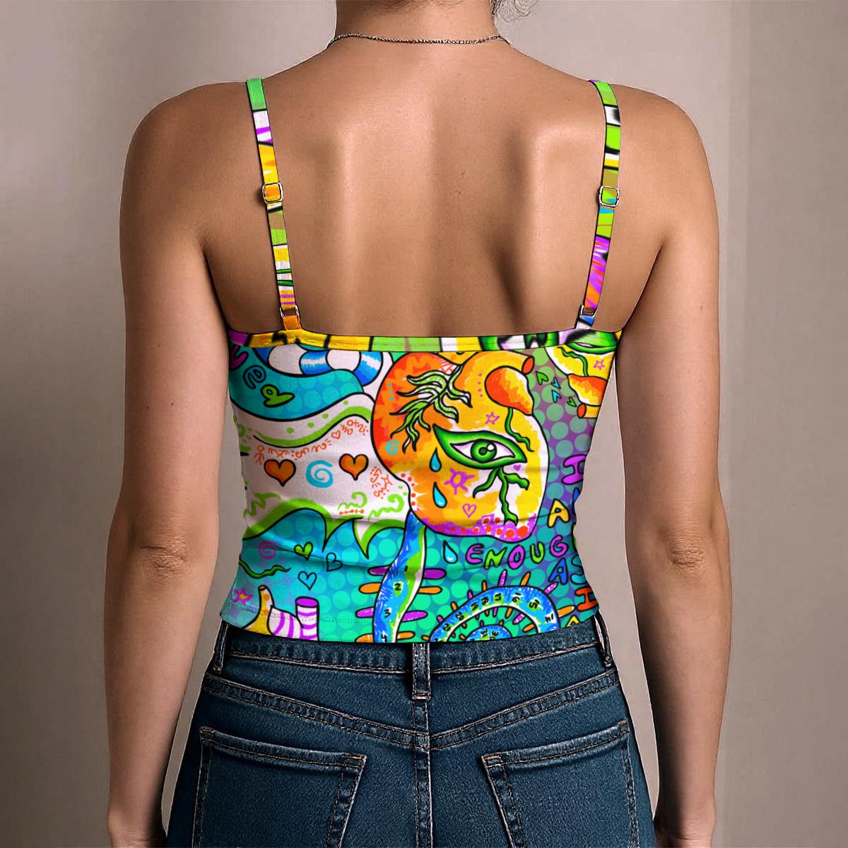 A woman shown from the back wearing a colorful spaghetti-strap bodysuit with a vibrant psychedelic graphic print, paired with blue jeans, against a plain beige background.