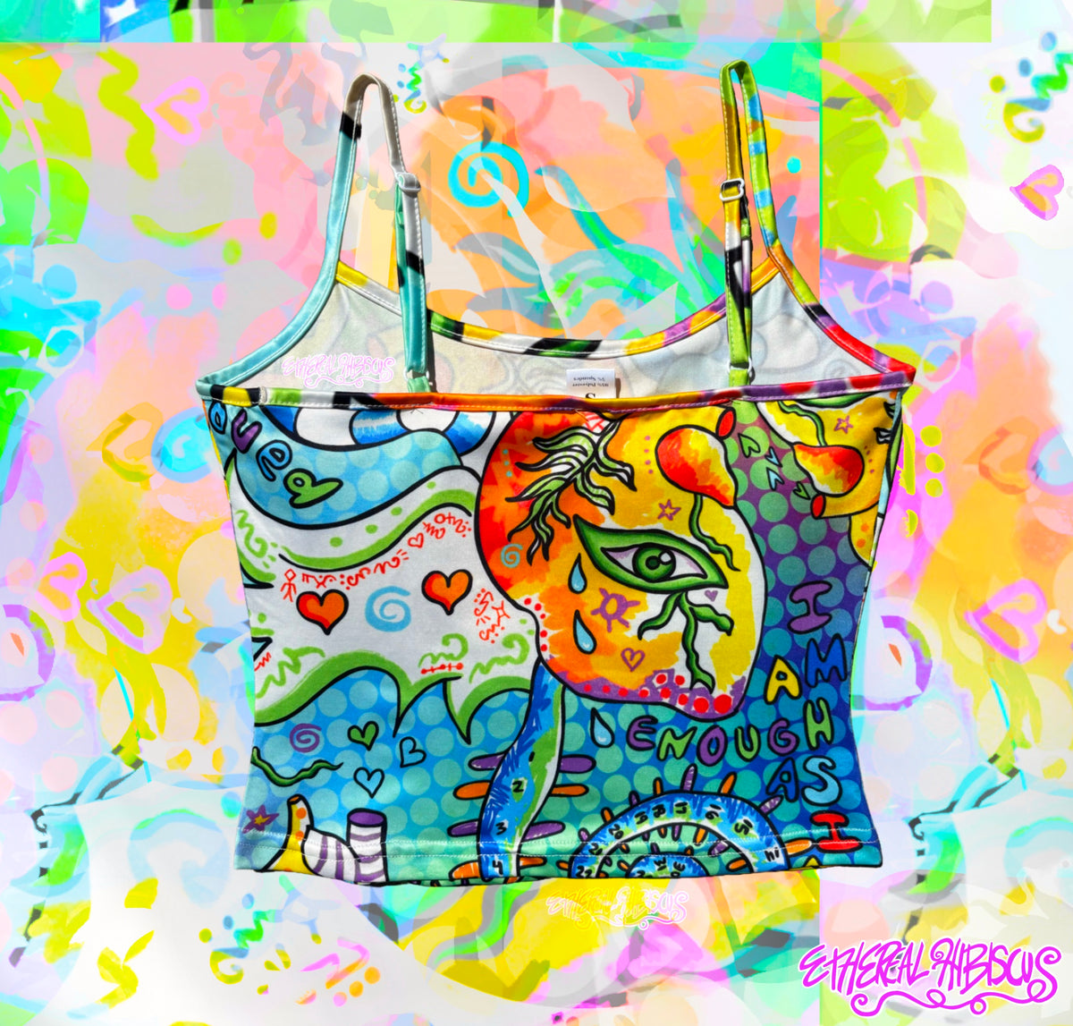 A colorful crop top featuring a vibrant psychedelic art print with a stylized face, hearts, and abstract shapes, set against a matching splattered pastel background.