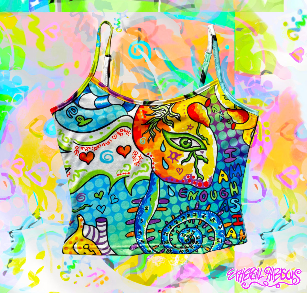 A colorful graphic crop top with thin straps, featuring a vibrant psychedelic illustration of a heart with eyes and wings,, and abstract shapes in blue, yellow, green, and pink, set against a matching abstract splattered background.
