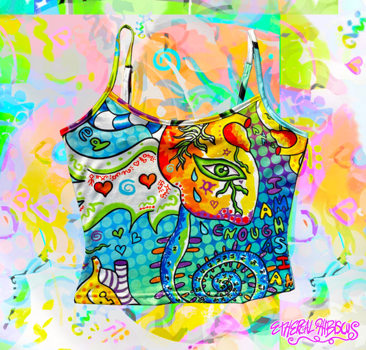A colorful graphic crop top with thin straps, featuring a vibrant psychedelic illustration of a heart with eyes and wings,, and abstract shapes in blue, yellow, green, and pink, set against a matching abstract splattered background.
